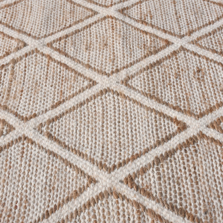 Chik handwoven wool and jute rug with a carved diamond lattice in ivory and natural, in a living room
