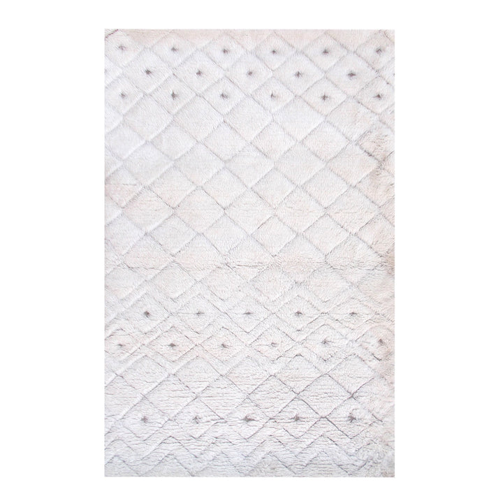 Til handwoven New Zealand wool flatweave rug with an ivory diamond lattice and dots, in a living room