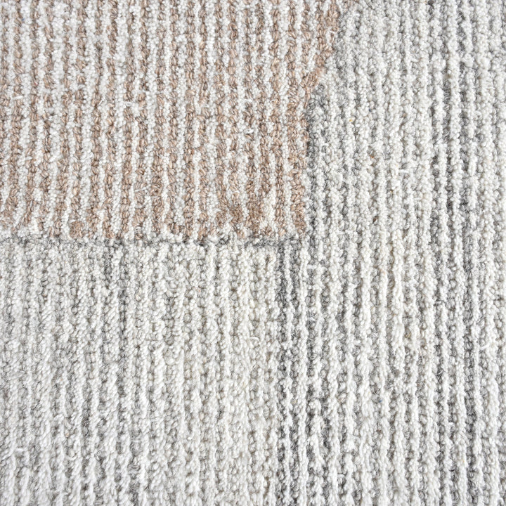 Ghera handwoven pale grey wool rug with overlapping cream circles, in a living room