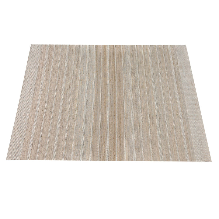 Taar handwoven wool and jute rug with fine vertical ribs in bleached natural and ivory, in a bedroom