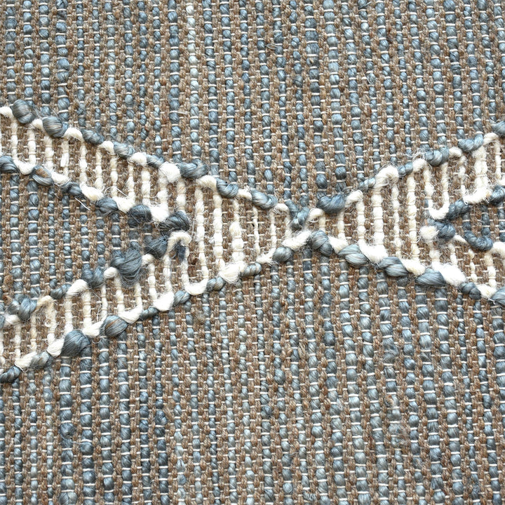 Thyme handwoven hemp rug with an ivory diamond lattice on sage grey, in a dining room