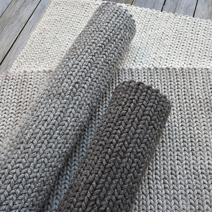 Dor handwoven chunky wool rug in charcoal, woven in thick cords, in a living room