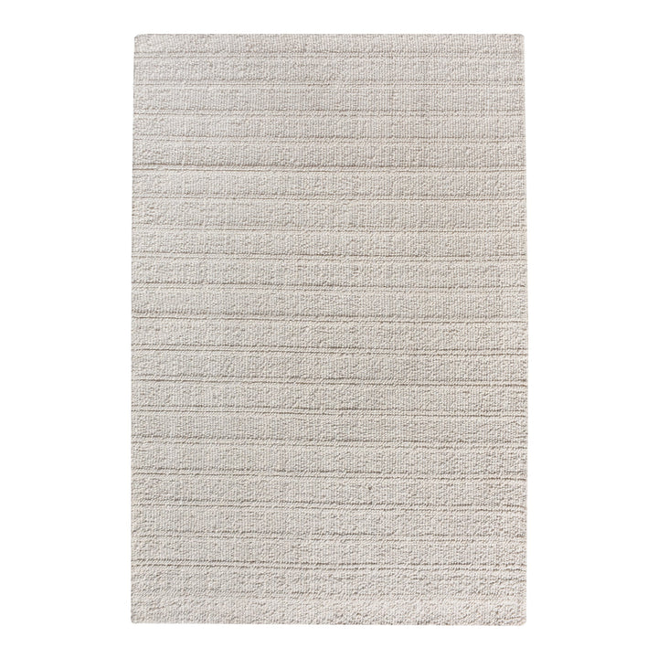 Oon handwoven ribbed wool rug in undyed oatmeal with horizontal ribs, under a coffee table