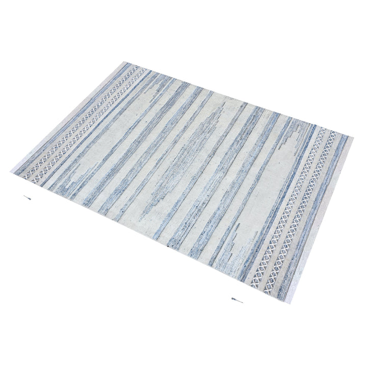 Breton handwoven denim and wool rug with blue and cream horizontal stripes, in a home office