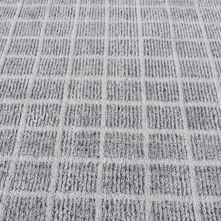 Baramda hand-loomed recycled PET rug with fine white grid lines on pale grey, on a verandah