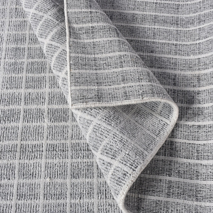 Baramda hand-loomed recycled PET rug with fine white grid lines on pale grey, on a verandah