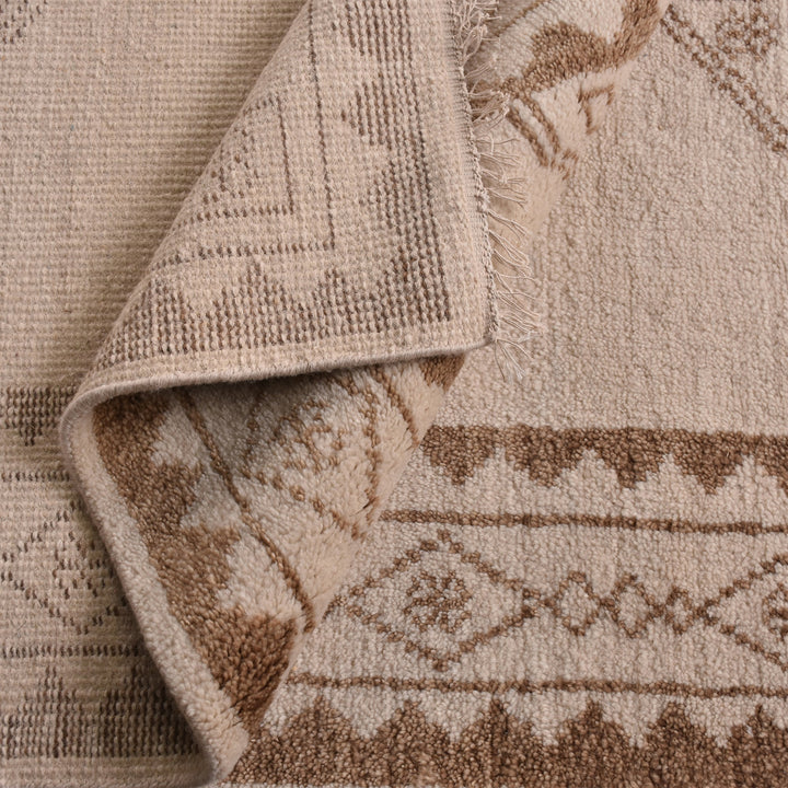 Gulab hand-knotted NZ wool rug with a blush medallion on an ivory field, in a bedroom