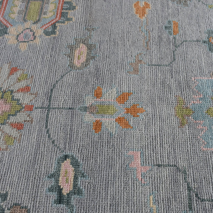 Purana hand-knotted wool rug with faded Oushak florals in slate blue-grey, rose, sage and gold