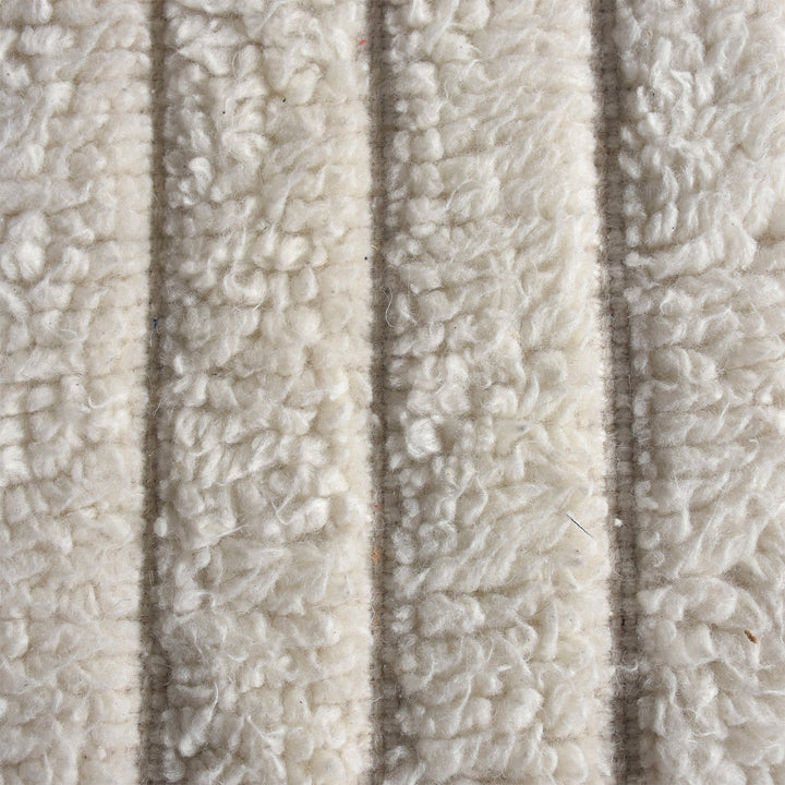 Sopan handwoven New Zealand wool rug with broad ivory ridges, in a living room