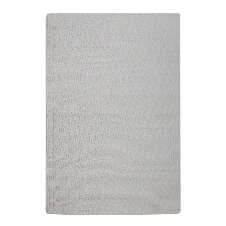 Jaal handwoven ivory wool rug with a raised cabled diamond lattice, in a living room