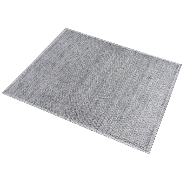 Raakh handwoven flatweave recycled PET rug in plain heather grey with fringe, in a living room