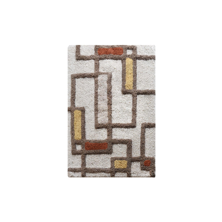Ochre Grid Cotton Bath Rug — An open geometric grid combines ivory with earthy brown and ochre accents.