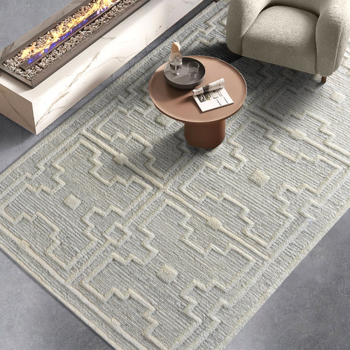 Chattan handwoven New Zealand wool rug with raised ivory diamonds on stone grey, in a living room