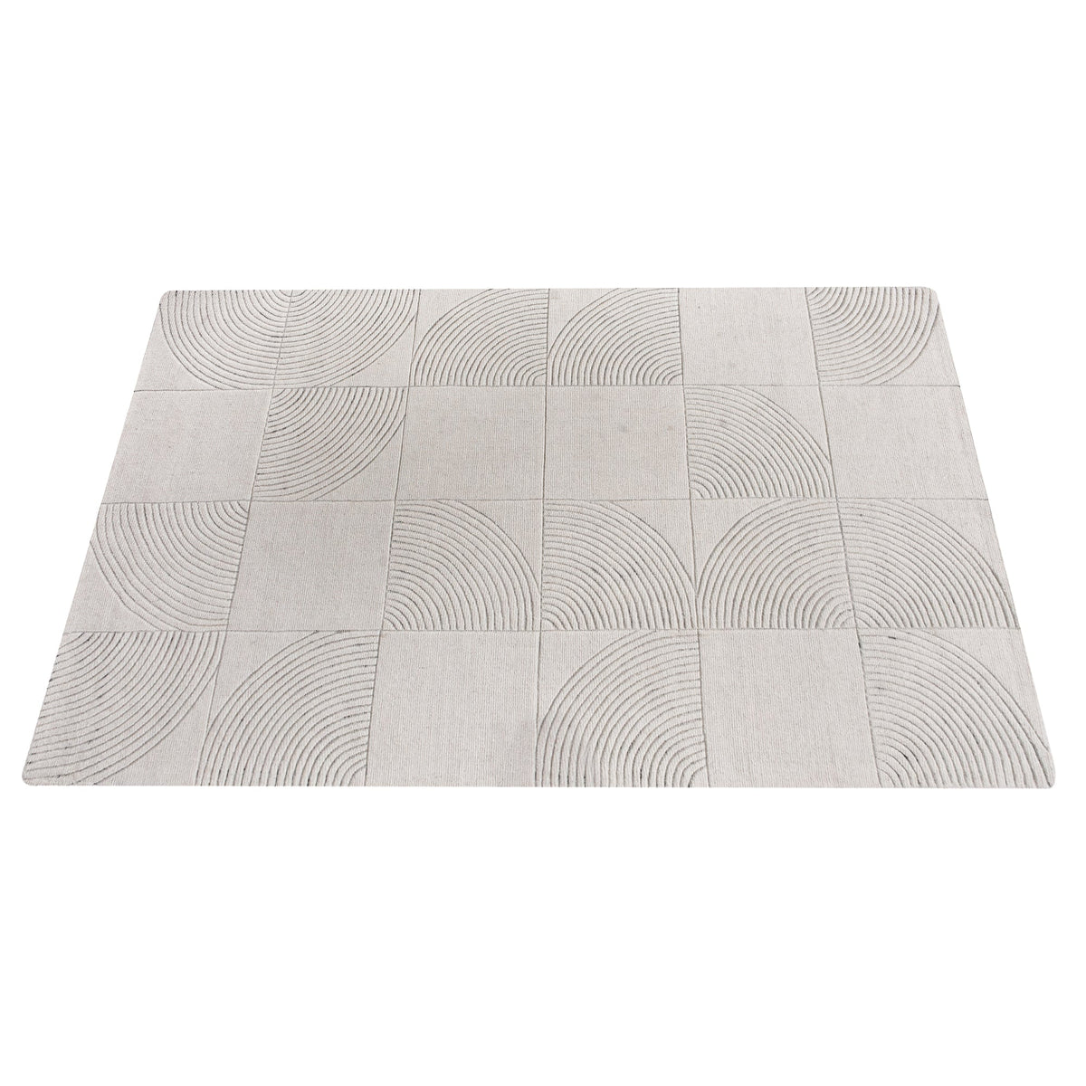 Seashell handwoven ivory wool rug with carved concentric arc tiles, in a bedroom