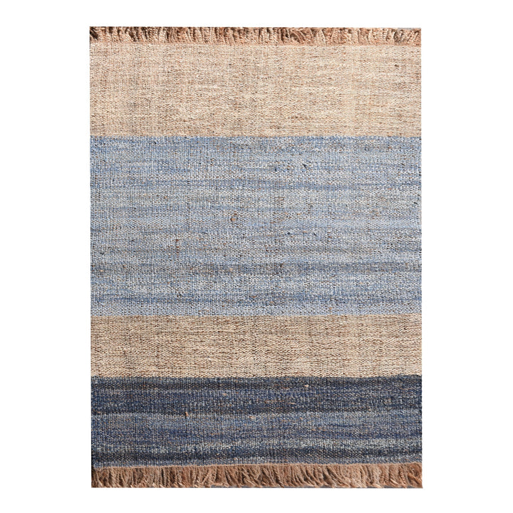Nahar flatweave hemp and denim rug with a denim-blue stripe on natural hemp, in a living room