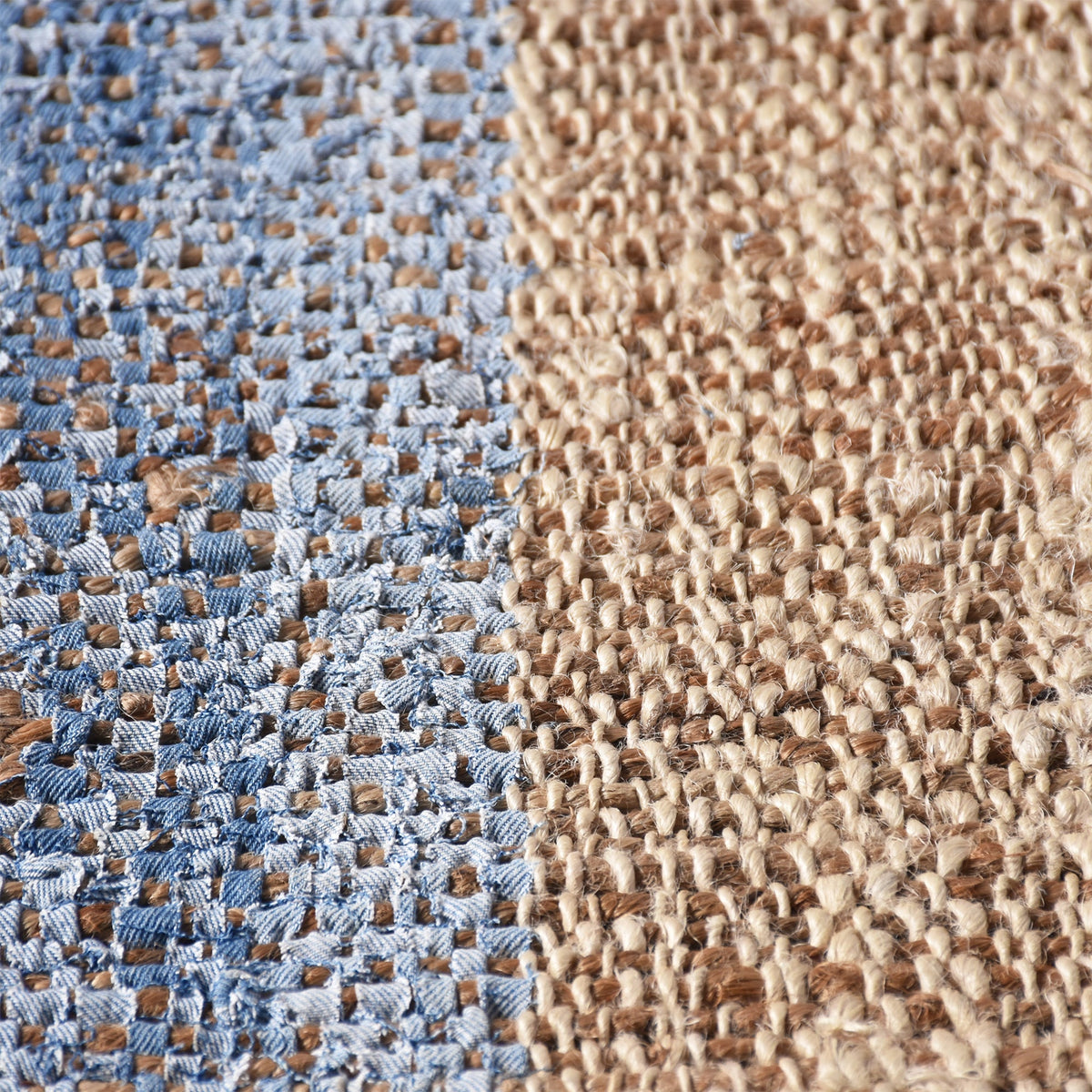 Nahar flatweave hemp and denim rug with a denim-blue stripe on natural hemp, in a living room