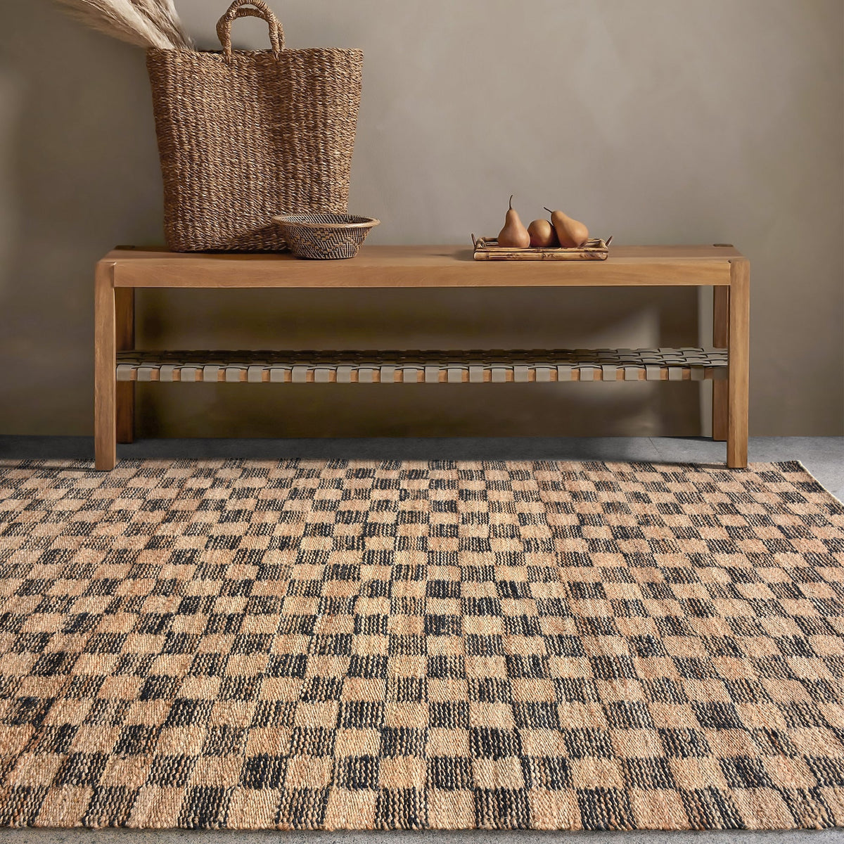 Chessboard handwoven jute rug with natural and charcoal checkerboard, in a living room