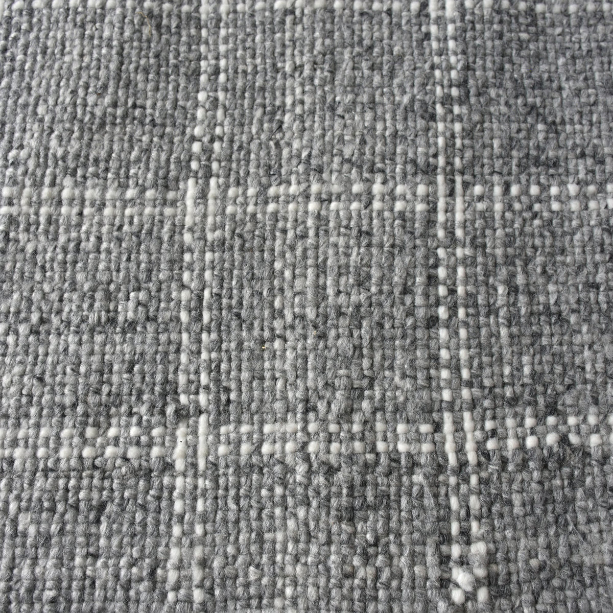 Pavilion handwoven slate grey and ivory recycled PET rug with a window-pane check, on a patio