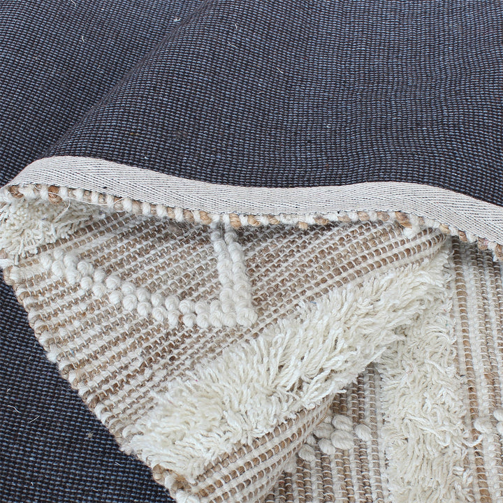Barley handwoven hemp and wool rug with raised ivory diamonds on cream, in a living room