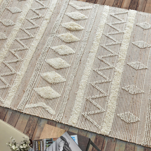 Barley handwoven hemp and wool rug with raised ivory diamonds on cream, in a living room