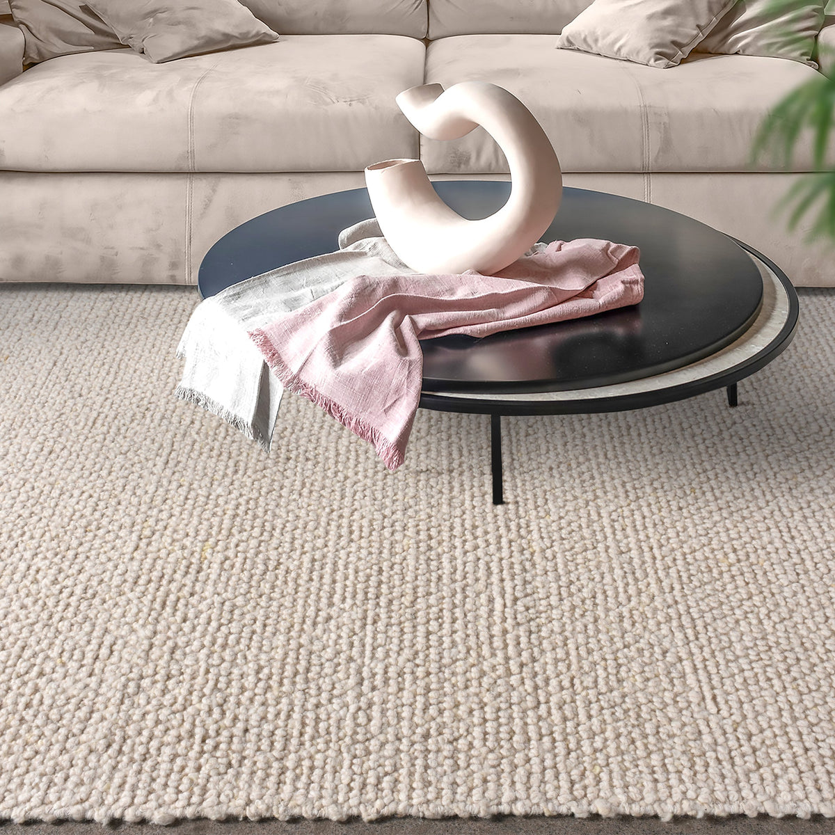 Bunai handwoven wool rug with a chunky looped bouclé surface in oatmeal, in a living room