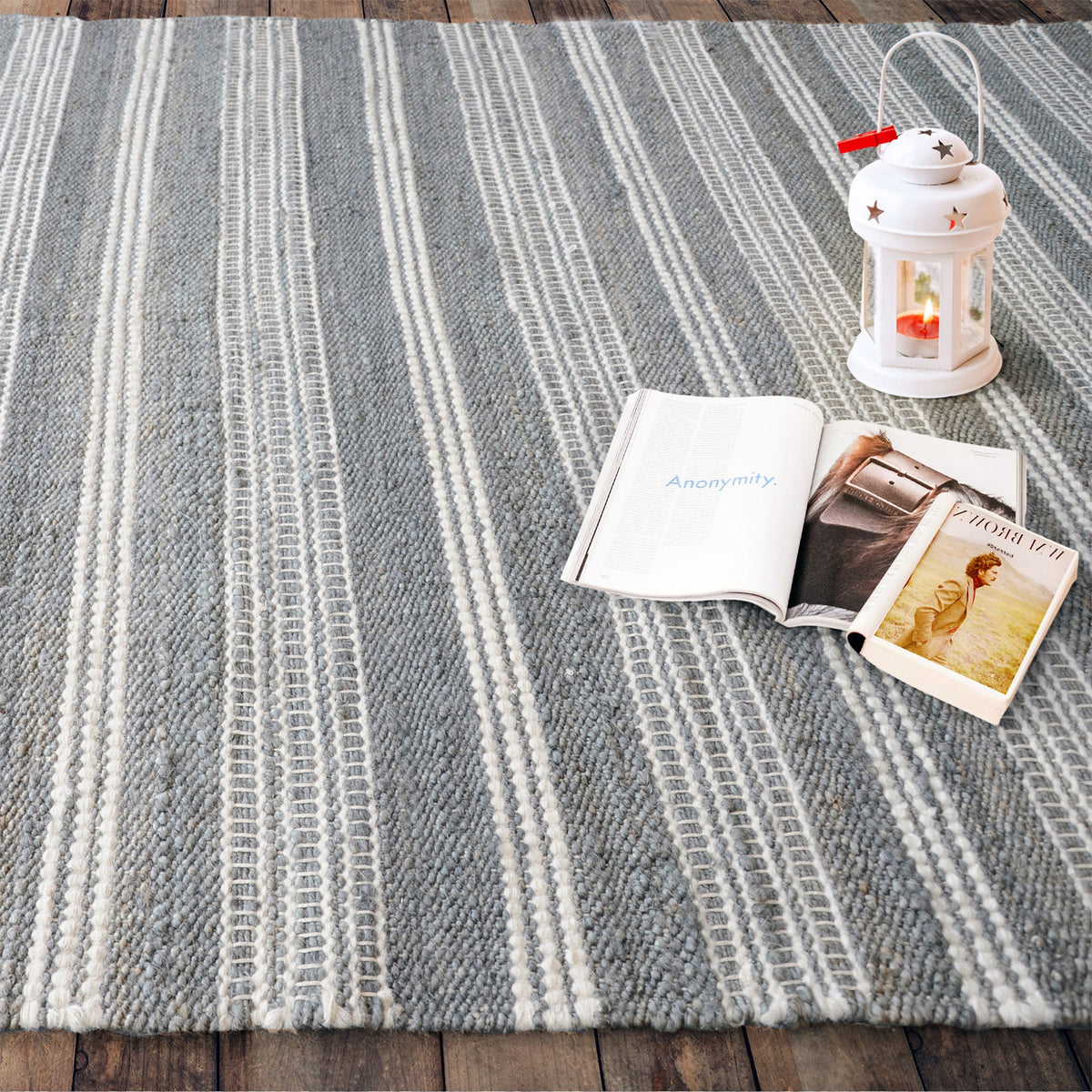 Pinstripe handwoven hemp and wool rug with slate and ivory vertical stripes, in a hallway