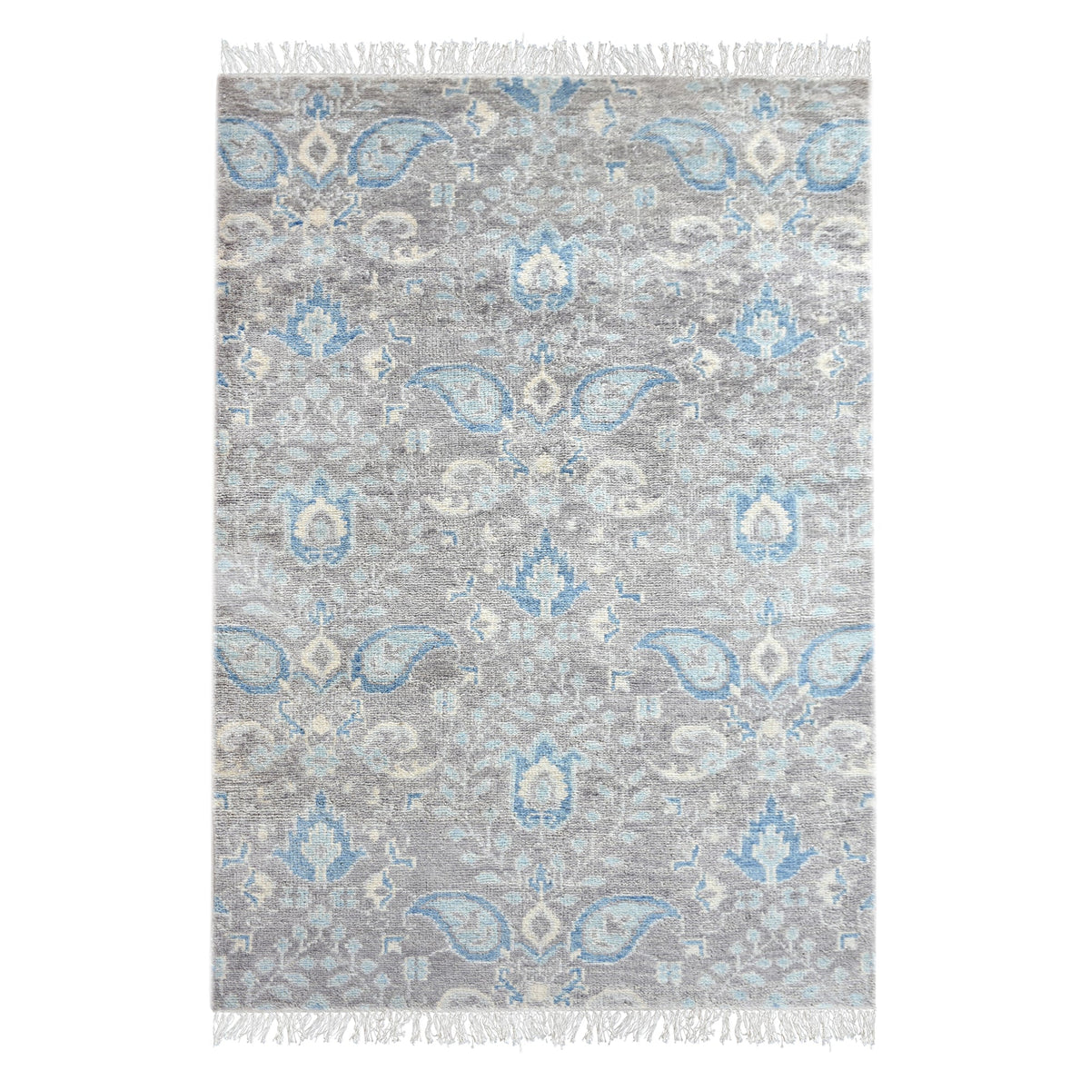 Kairi hand-knotted wool rug with blue paisley on a distressed taupe ground, in a living room