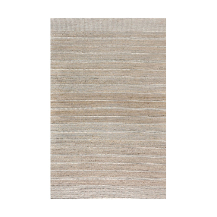 Taar handwoven wool and jute rug with fine vertical ribs in bleached natural and ivory, in a bedroom