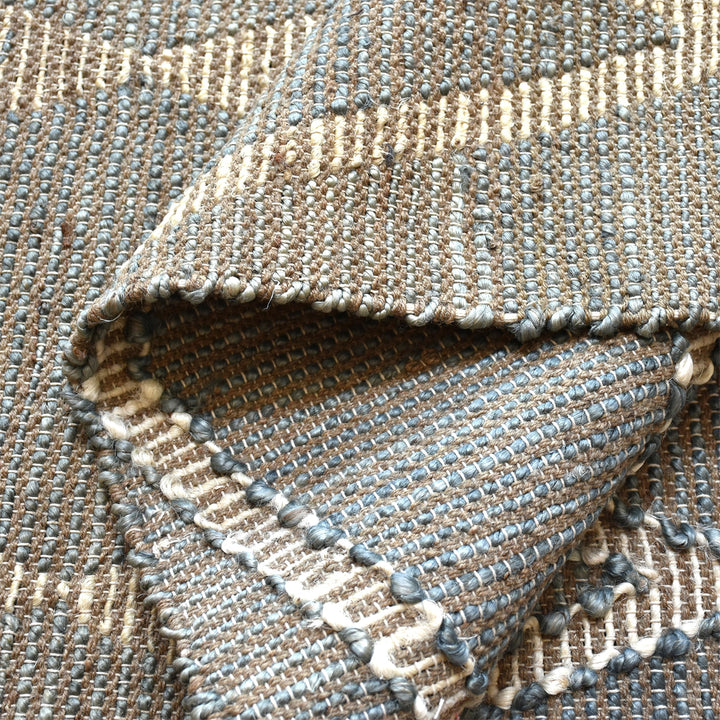 Thyme handwoven hemp rug with an ivory diamond lattice on sage grey, in a dining room