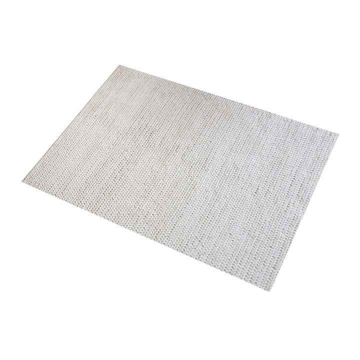 Dor handwoven chunky wool rug in charcoal, woven in thick cords, in a living room
