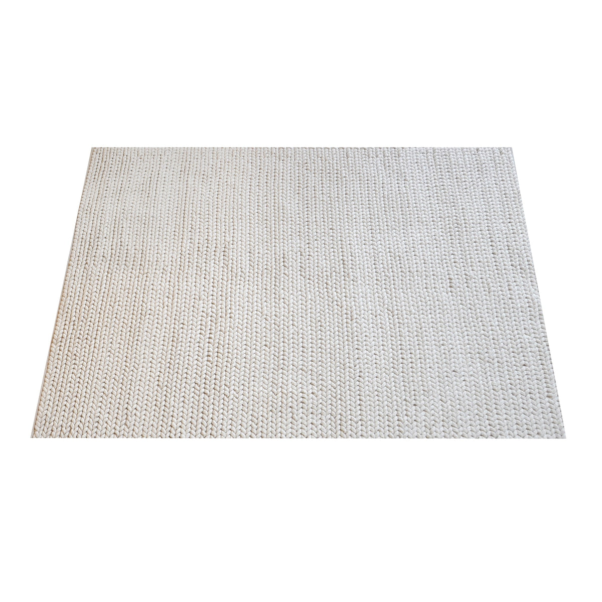 Dor handwoven chunky wool rug in charcoal, woven in thick cords, in a living room