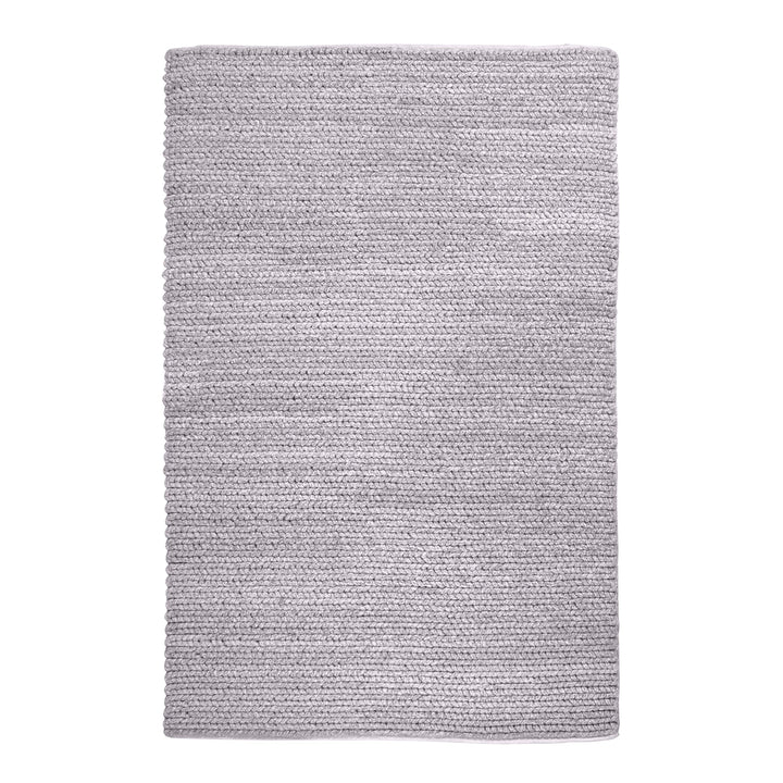 Dor handwoven chunky wool rug in charcoal, woven in thick cords, in a living room