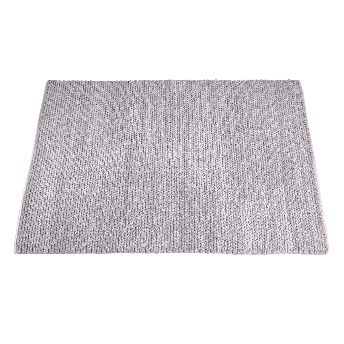 Dor handwoven chunky wool rug in charcoal, woven in thick cords, in a living room