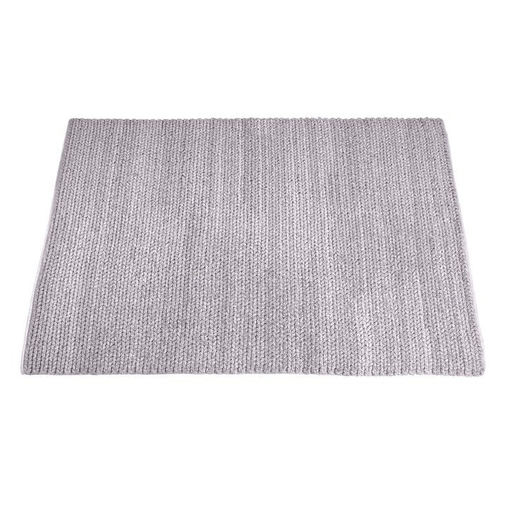 Dor handwoven chunky wool rug in charcoal, woven in thick cords, in a living room