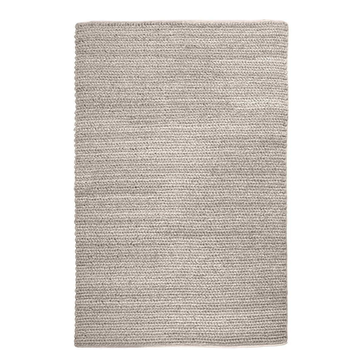 Dor handwoven chunky wool rug in charcoal, woven in thick cords, in a living room