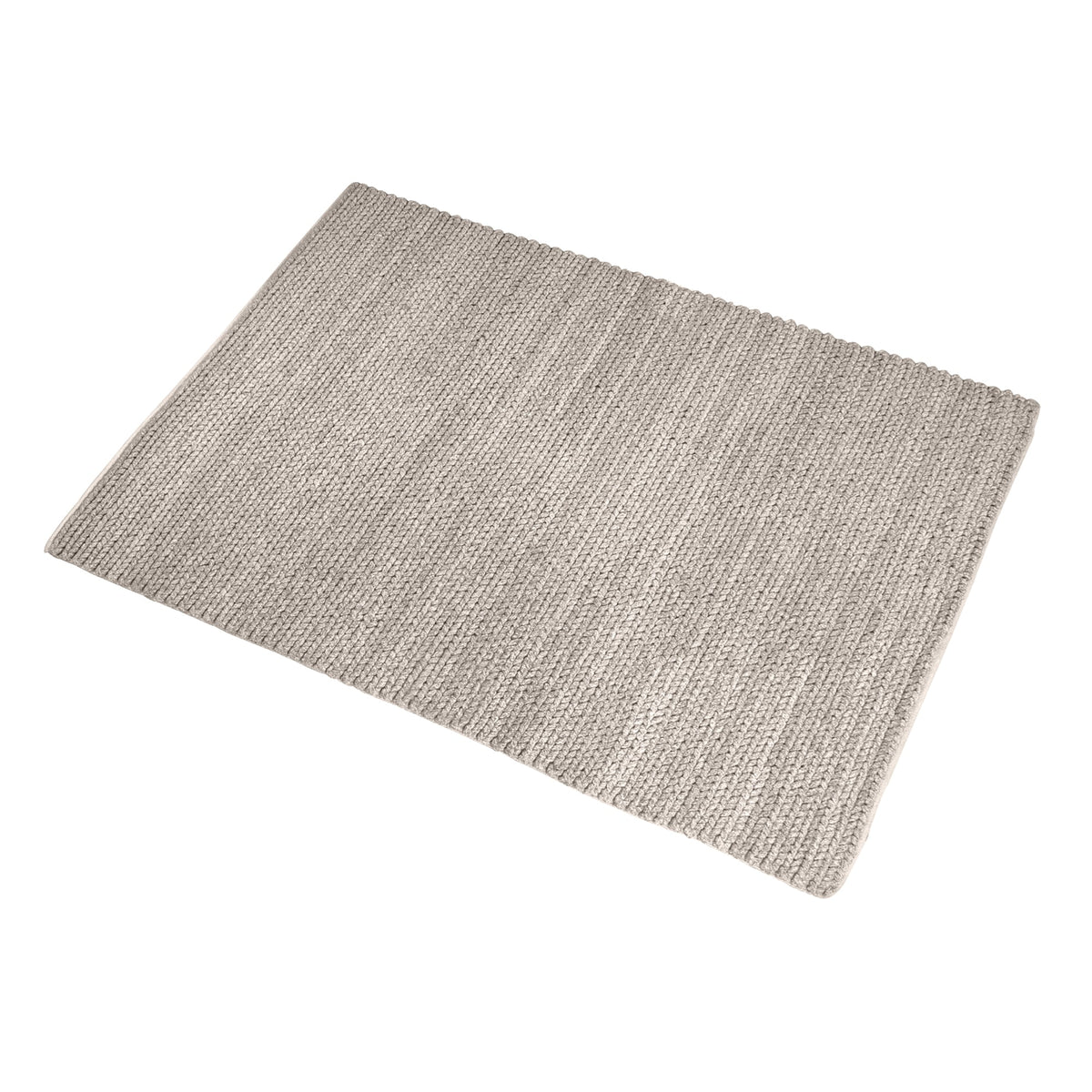 Dor handwoven chunky wool rug in charcoal, woven in thick cords, in a living room