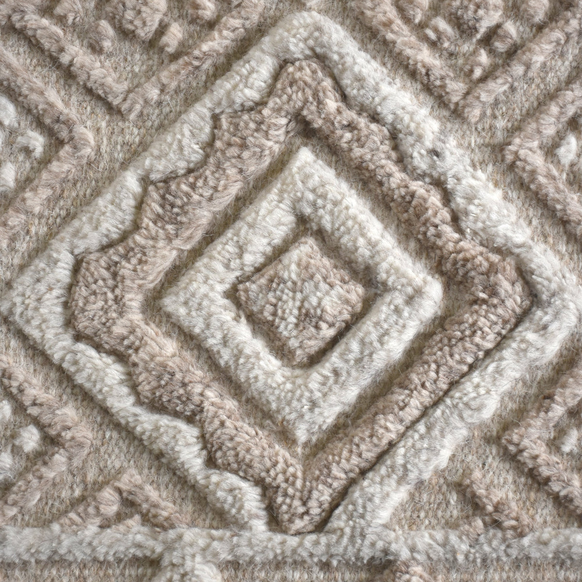 Malai hand-knotted ivory wool rug with a raised diamond lattice, under a dining table