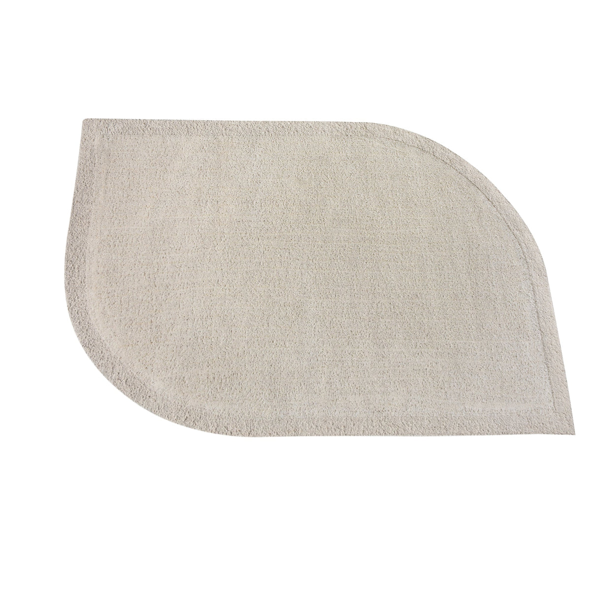 Gol handwoven wool rug in plain cream with a soft cut pile and a curved edge, in a nursery