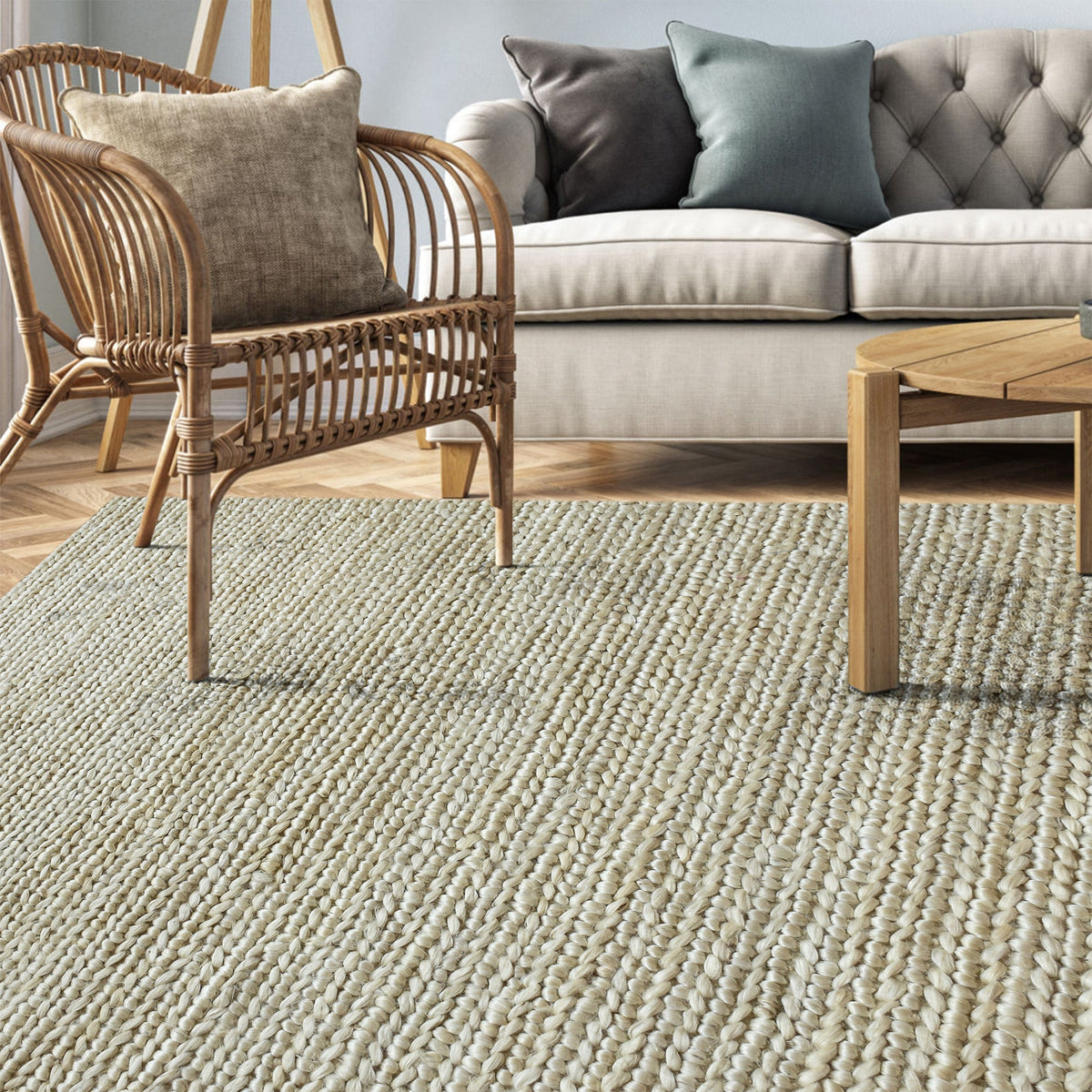 Kai handwoven hemp rug in natural with a sage cast and a tight chunky weave, in a living room