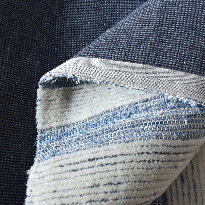 Breton handwoven denim and wool rug with blue and cream horizontal stripes, in a home office