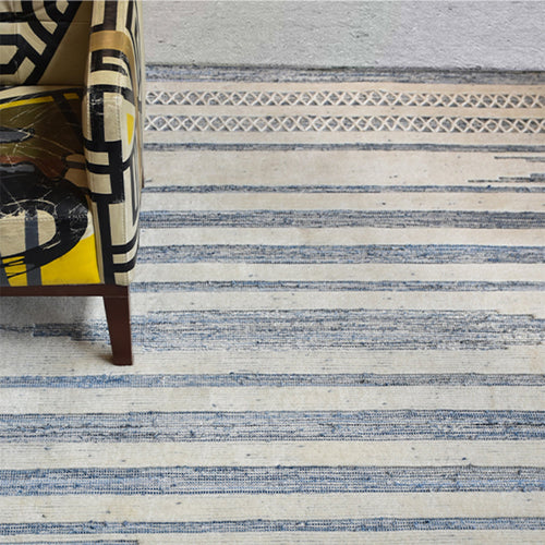 Breton handwoven denim and wool rug with blue and cream horizontal stripes, in a home office
