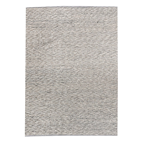 Rassi handwoven wool rug with a chunky braided weave in ivory, oatmeal and grey, in a living room