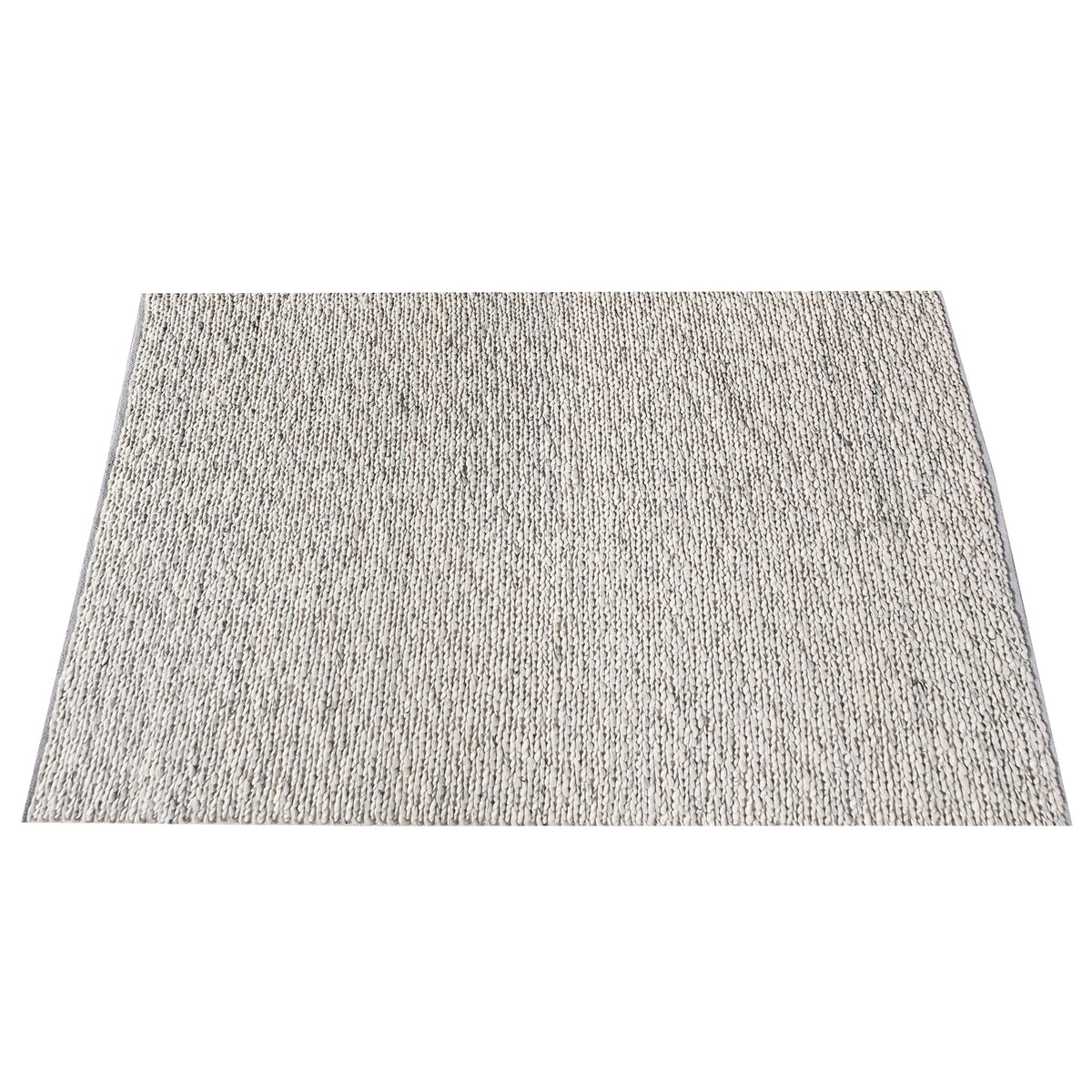 Rassi handwoven wool rug with a chunky braided weave in ivory, oatmeal and grey, in a living room
