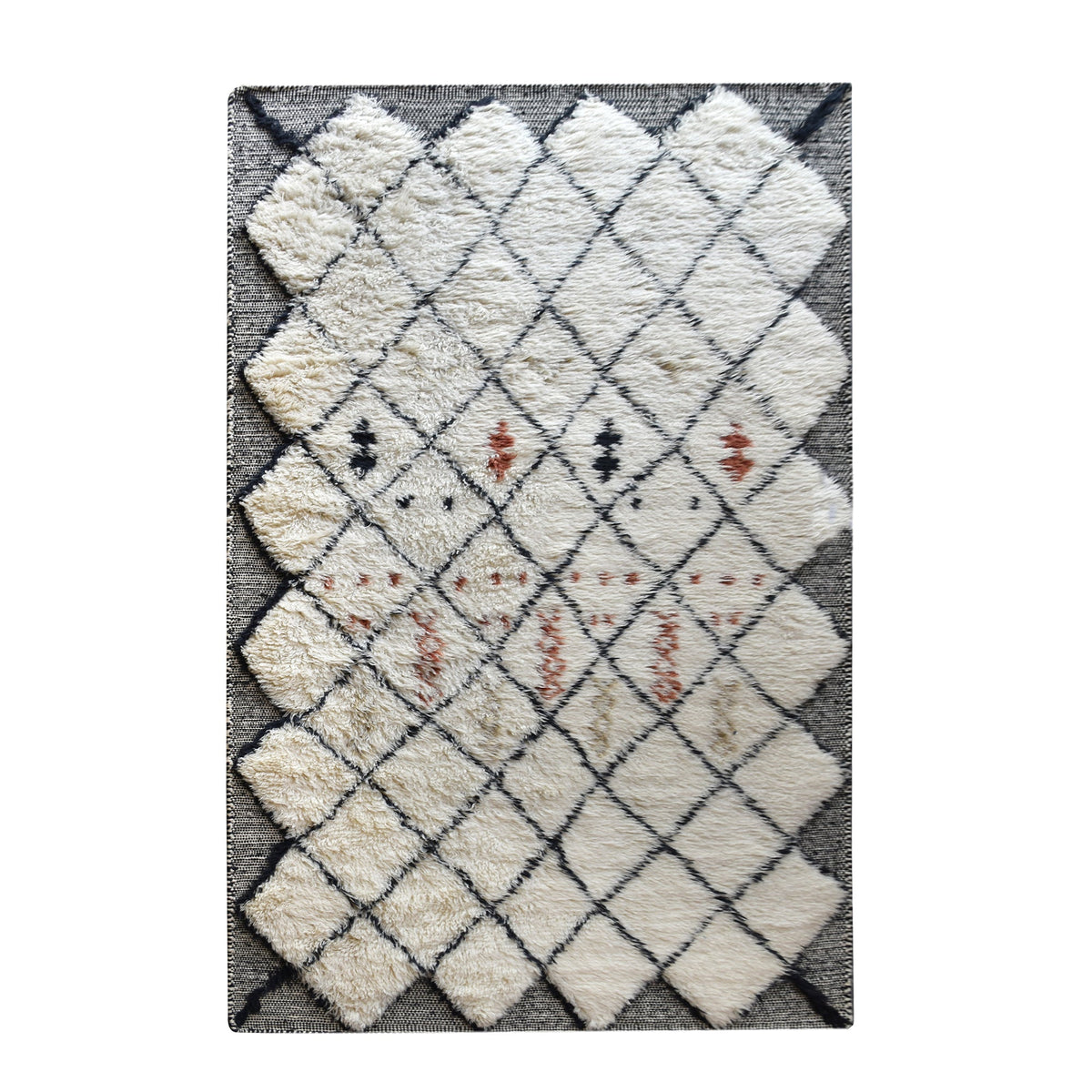 Kesar hand-knotted New Zealand wool shag rug in cream with a black diamond lattice and rust, in a bedroom
