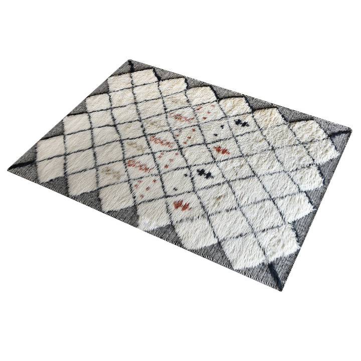 Kesar hand-knotted New Zealand wool shag rug in cream with a black diamond lattice and rust, in a bedroom