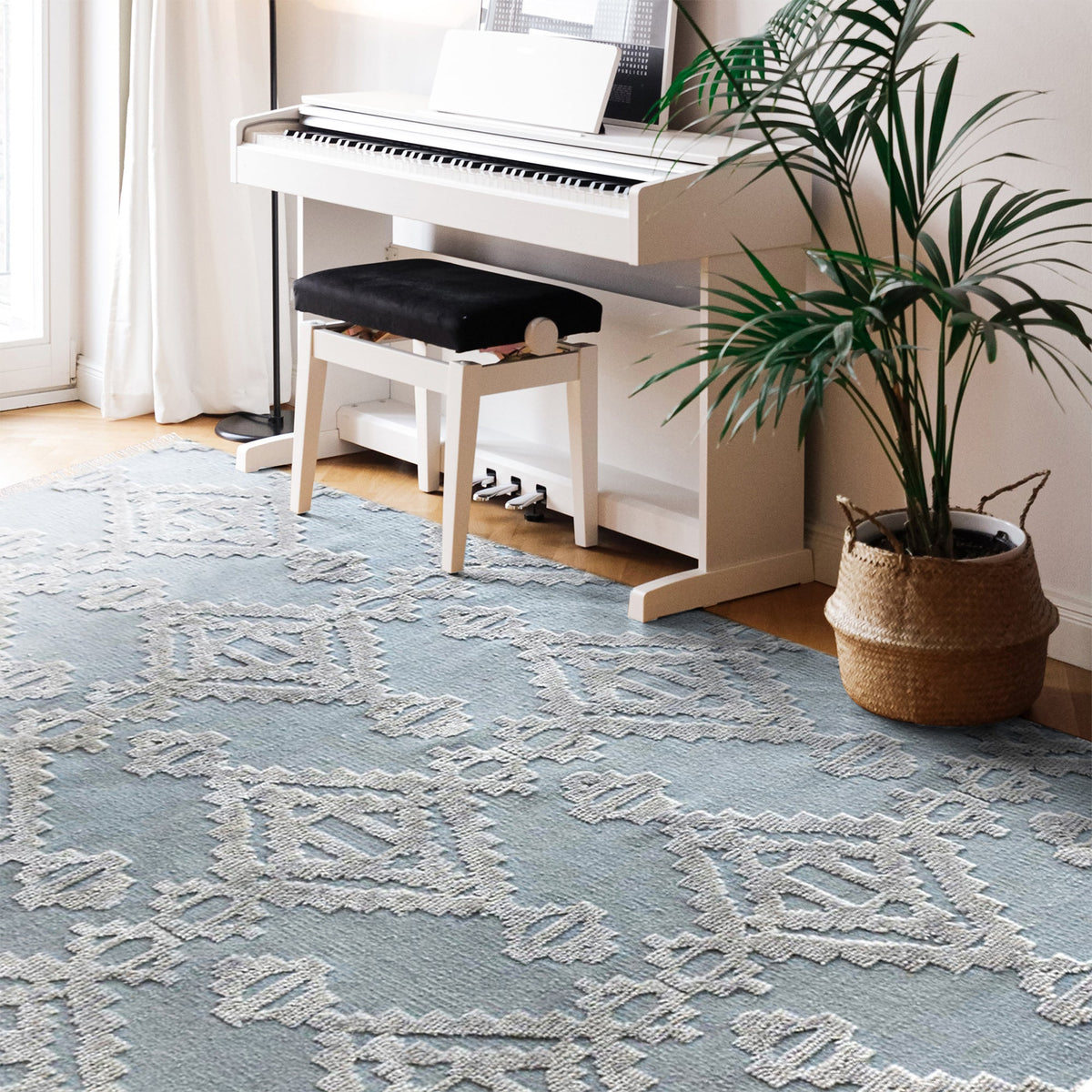 Mor hand-knotted wool rug with ivory raised diamonds on duck egg blue, in a bedroom