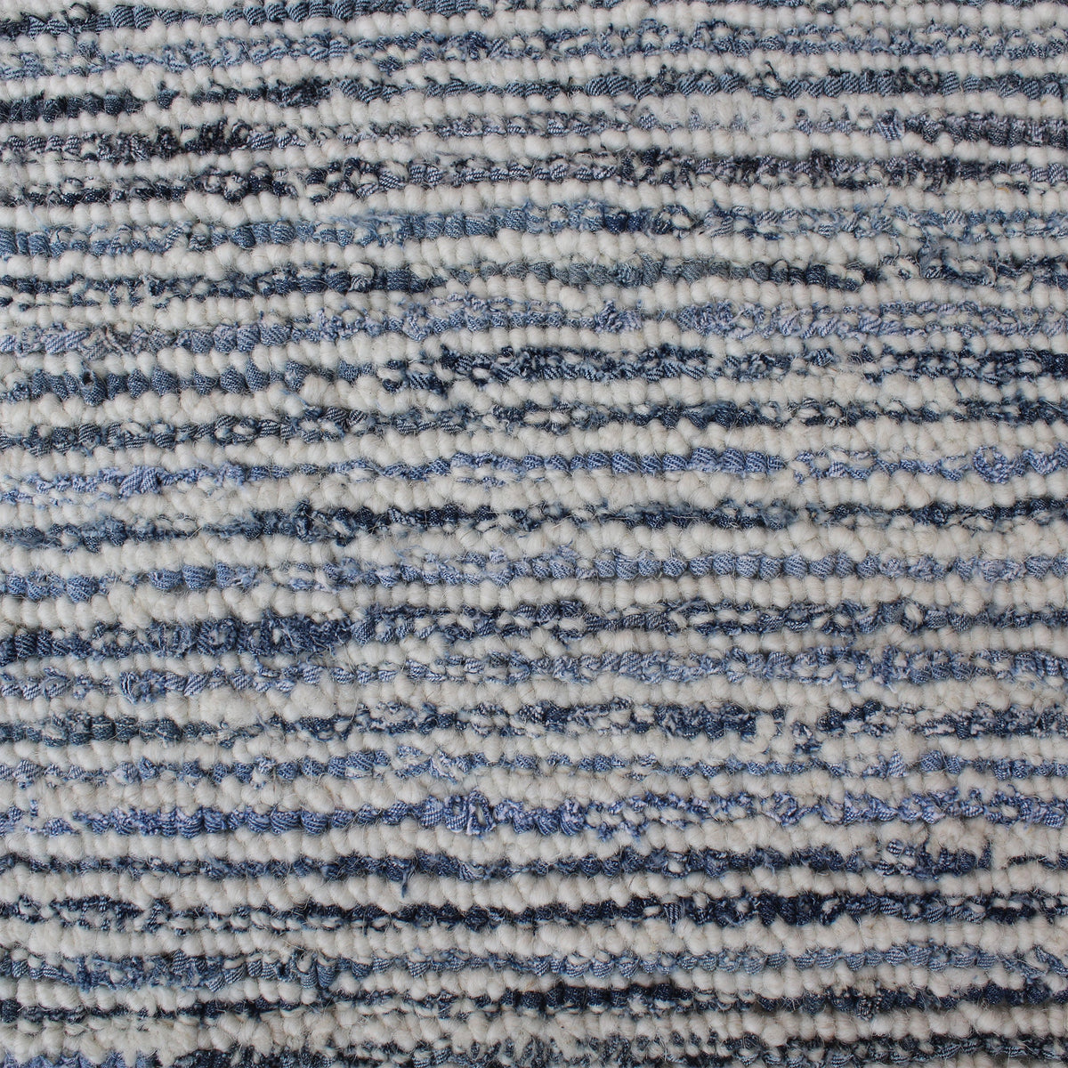 Estuary handwoven wool and denim rug with denim blue contour lines on ivory, in a dining room