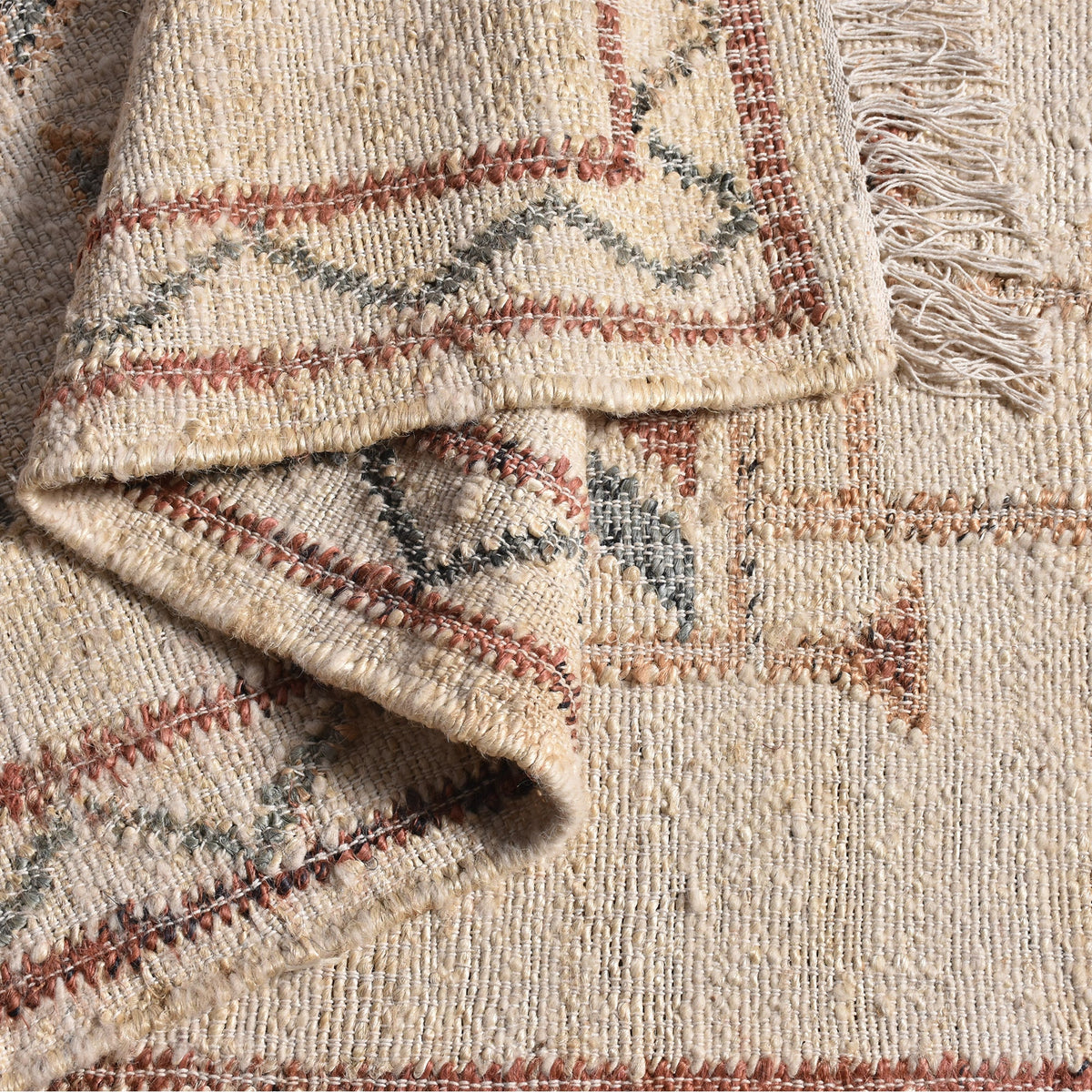 Lok handwoven wool and jute kilim flatweave rug with rust tribal motifs on a natural ground