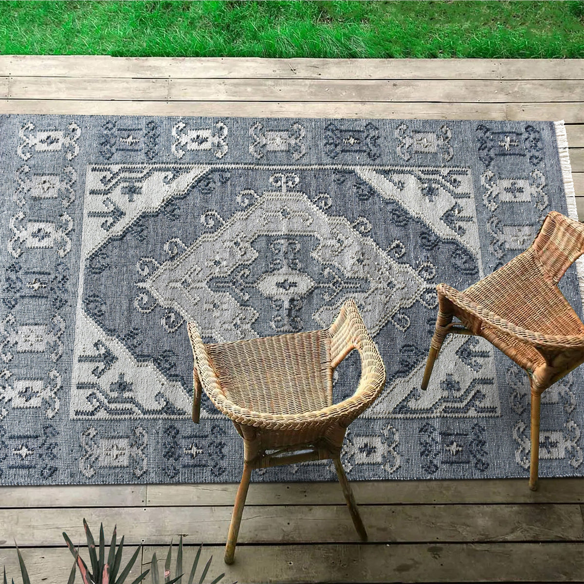 Courtyard flatweave slate blue recycled PET rug with an ivory Heriz medallion, on a patio