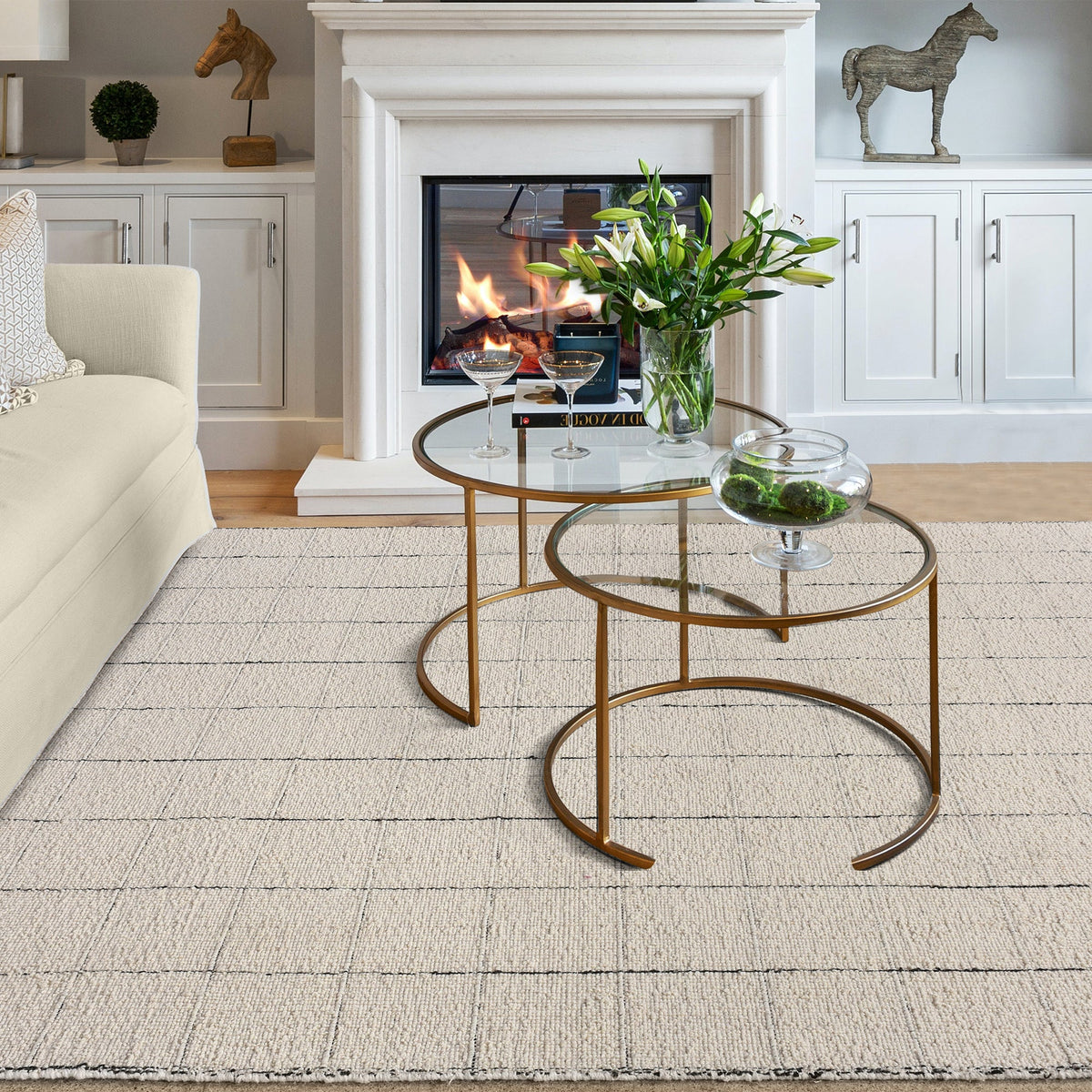 Khidki handwoven wool flatweave rug with fine charcoal grid lines on ivory, in a living room
